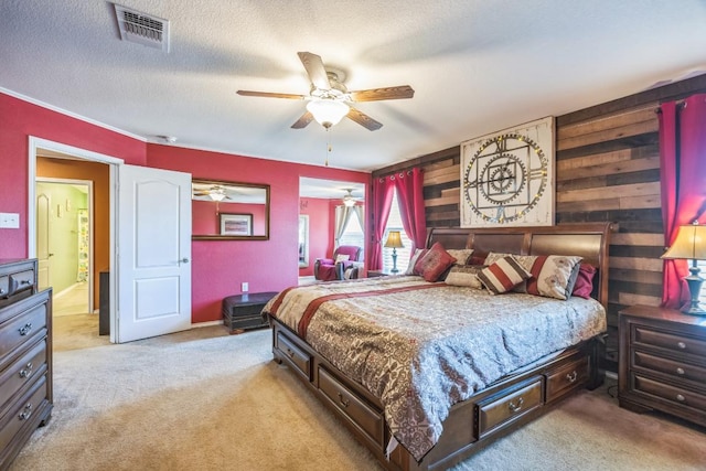 6401 Quinton Dr, Austin, TX 78747 - bedroom featuring light carpet, a textured ceiling, ceiling fan, and wooden walls