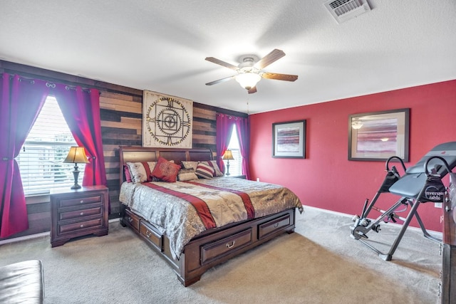 6401 Quinton Dr, Austin, TX 78747 - bedroom with carpet flooring, wooden walls, a ceiling fan, and a textured ceiling