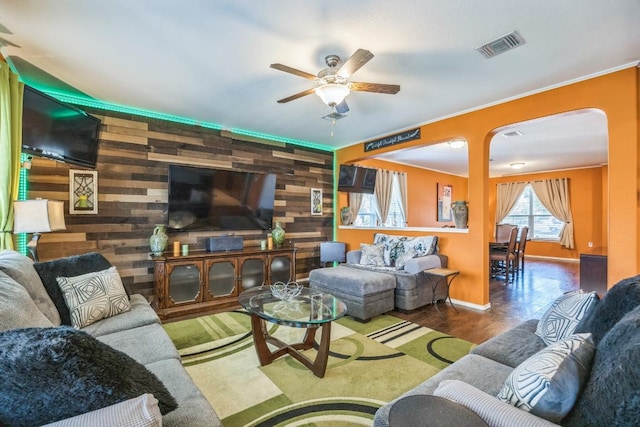 6401 Quinton Dr, Austin, TX 78747 - living area with wooden walls, a ceiling fan, wood finished floors, and crown molding