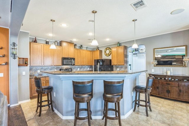 6401 Quinton Dr, Austin, TX 78747 - kitchen with black appliances, ornamental molding, decorative backsplash, a breakfast bar area, and pendant lighting
