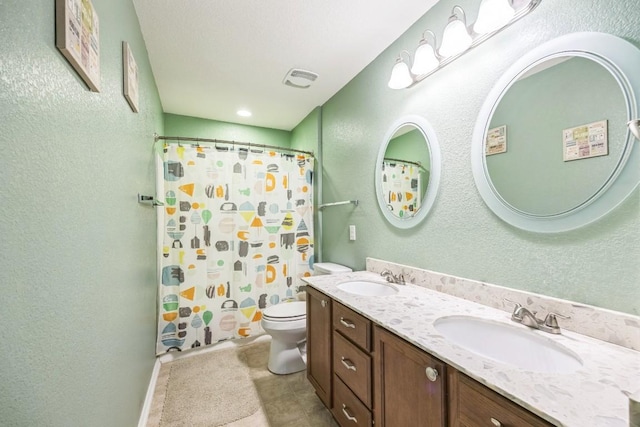 6401 Quinton Dr, Austin, TX 78747 - full bathroom with double vanity, tile patterned floors, curtained shower, and a textured wall