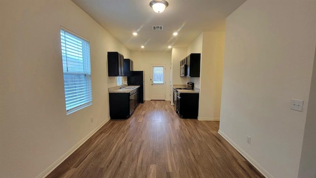 850 Bunton Reserve Blvd, Kyle, TX 78640 - kitchen featuring stove, dark cabinetry, light countertops, and lofted ceiling