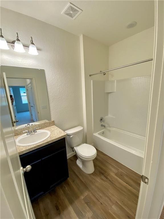 850 Bunton Reserve Blvd, Kyle, TX 78640 - bathroom with vanity, wood finished floors, bathing tub / shower combination, and a textured wall