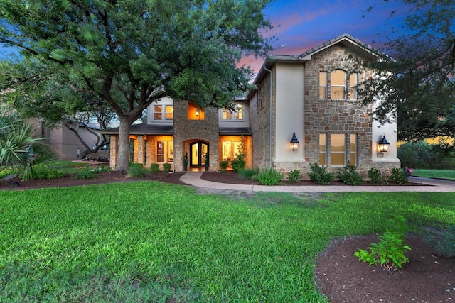 14417 Heron Bay Cv, Bee Cave, TX 78738 - view of front of house with stone siding, a lawn, and stucco siding