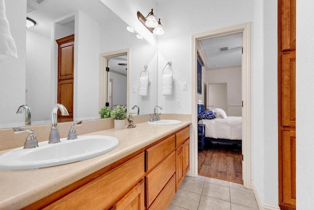 14417 Heron Bay Cv, Bee Cave, TX 78738 - ensuite bathroom with double vanity and tile patterned flooring