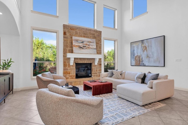 14417 Heron Bay Cv, Bee Cave, TX 78738 - living area with light tile patterned floors, a high ceiling, healthy amount of natural light, and a fireplace