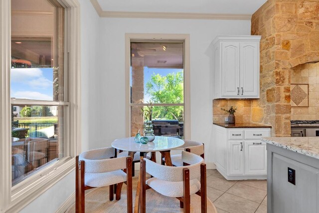 14417 Heron Bay Cv, Bee Cave, TX 78738 - dining space featuring light tile patterned flooring and crown molding