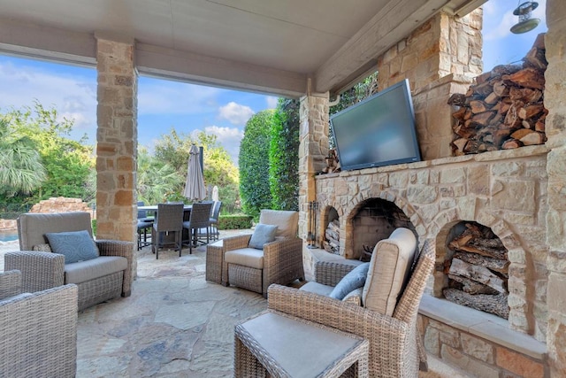14417 Heron Bay Cv, Bee Cave, TX 78738 - view of patio with an outdoor stone fireplace and outdoor dining area