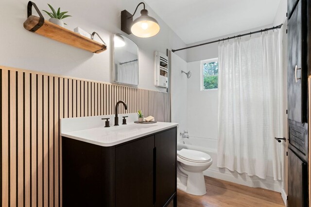 1040 Rosemont St, Austin, TX 78723 - full bathroom with vanity, shower / bath combo with shower curtain, and wood finished floors