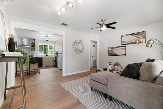 1040 Rosemont St, Austin, TX 78723 - living area featuring a ceiling fan, light wood-style flooring, and a baseboard radiator