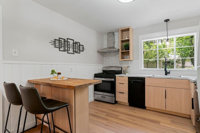 1040 Rosemont St, Austin, TX 78723 - kitchen featuring stainless steel range with gas stovetop, wall chimney range hood, black dishwasher, light brown cabinets, and butcher block countertops