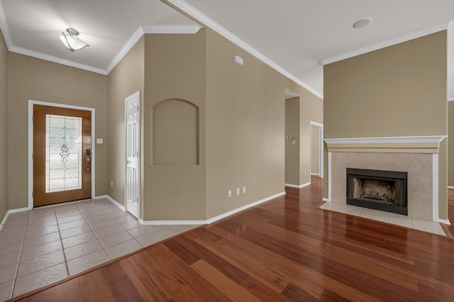 202 Muscovy Ln, Cedar Park, TX 78613 - entryway featuring crown molding, wood finished floors, and a tiled fireplace
