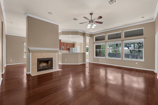 202 Muscovy Ln, Cedar Park, TX 78613 - unfurnished living room featuring ceiling fan, wood finished floors, crown molding, and a tile fireplace