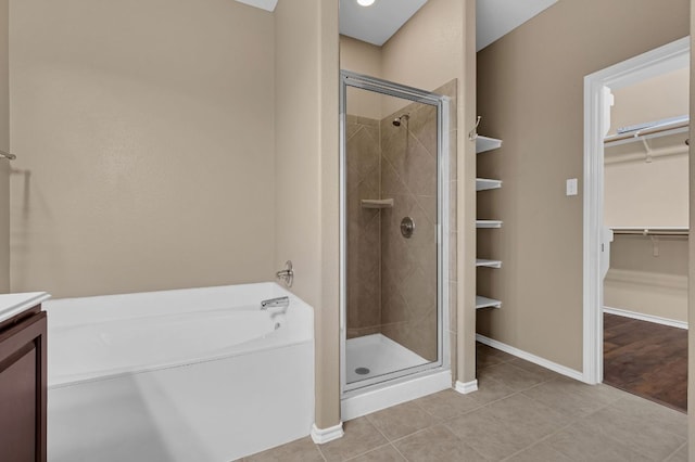 202 Muscovy Ln, Cedar Park, TX 78613 - bathroom with a shower stall, a spacious closet, a garden tub, and tile patterned flooring