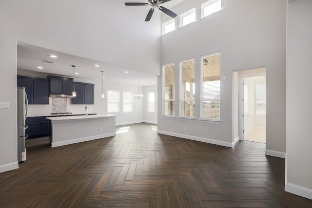 2321 Clear Pond Vw, Leander, TX 78641 - unfurnished living room with a high ceiling, a ceiling fan, a chandelier, and recessed lighting