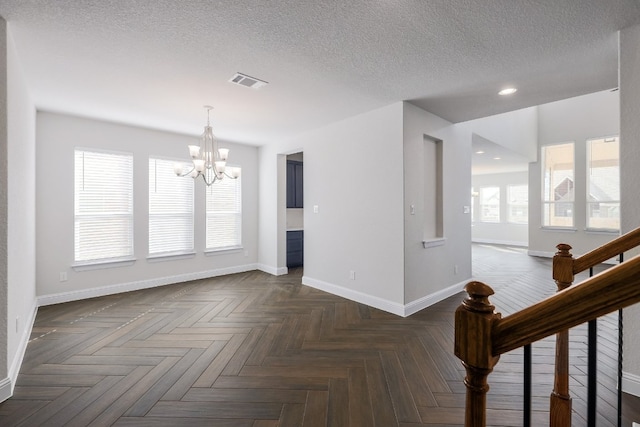 2321 Clear Pond Vw, Leander, TX 78641 - empty room with a chandelier, a textured ceiling, and recessed lighting