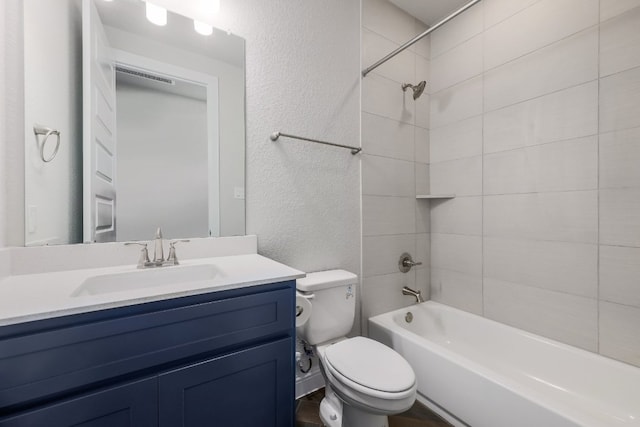 2321 Clear Pond Vw, Leander, TX 78641 - full bathroom featuring a textured wall, vanity, and shower / bathtub combination