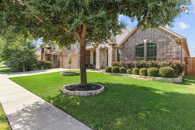 2707 Saint Paul Rivera Ln, Round Rock, TX 78665 - view of property hidden behind natural elements with driveway, stone siding, brick siding, and a garage