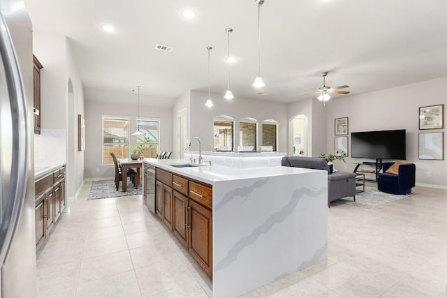 2707 Saint Paul Rivera Ln, Round Rock, TX 78665 - kitchen featuring arched walkways, appliances with stainless steel finishes, a ceiling fan, light tile patterned flooring, and recessed lighting