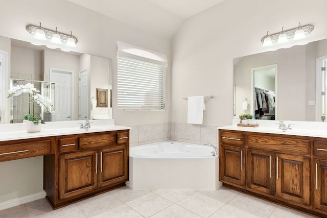 2707 Saint Paul Rivera Ln, Round Rock, TX 78665 - bathroom featuring a shower stall, tile patterned floors, two vanities, a bath, and a spacious closet