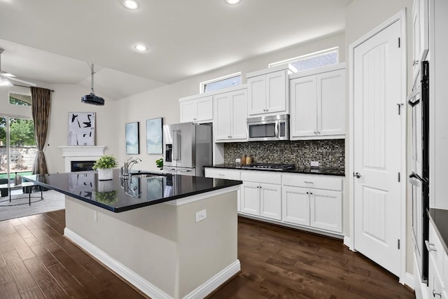 14016 Tyburn Trl, Austin, TX 78717 - kitchen featuring stainless steel appliances, dark countertops, dark wood-style flooring, tasteful backsplash, and lofted ceiling