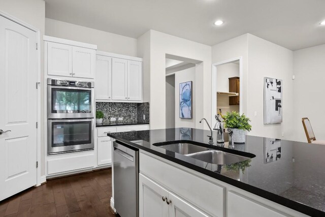 14016 Tyburn Trl, Austin, TX 78717 - kitchen featuring stainless steel appliances, dark wood-style flooring, decorative backsplash, white cabinets, and recessed lighting