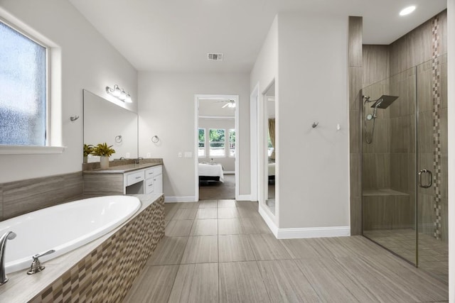 14016 Tyburn Trl, Austin, TX 78717 - ensuite bathroom featuring vanity, a stall shower, a bath, tile patterned floors, and ceiling fan
