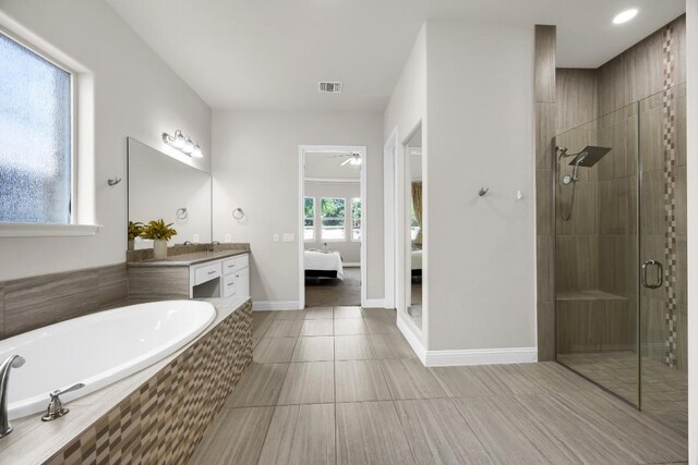 14016 Tyburn Trl, Austin, TX 78717 - bathroom with vanity, ensuite bathroom, a shower stall, a bath, and tile patterned flooring
