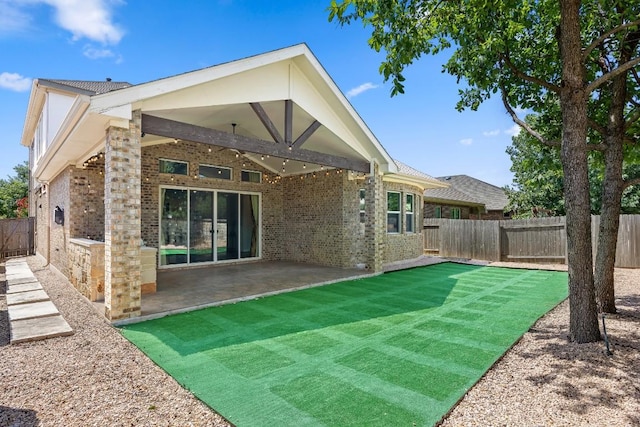 14016 Tyburn Trl, Austin, TX 78717 - back of property with brick siding, a patio area, and a fenced backyard