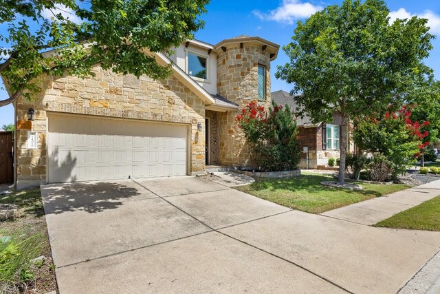 14016 Tyburn Trl, Austin, TX 78717 - view of front facade featuring stone siding, driveway, a garage, and a front yard