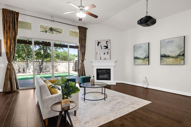 14016 Tyburn Trl, Austin, TX 78717 - living room with ceiling fan, a glass covered fireplace, dark wood-style floors, and vaulted ceiling