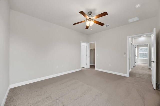 14016 Tyburn Trl, Austin, TX 78717 - unfurnished bedroom featuring carpet, a ceiling fan, and a walk in closet