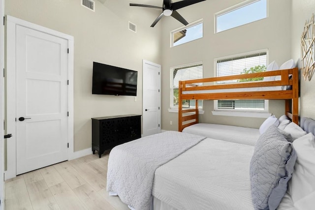 7215 Bennett Ave, Austin, TX 78752 - bedroom featuring light wood finished floors, a high ceiling, and ceiling fan