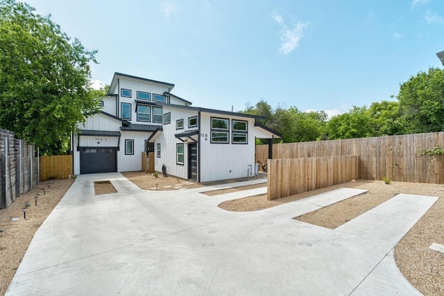 7215 Bennett Ave, Austin, TX 78752 - contemporary home featuring concrete driveway and a garage