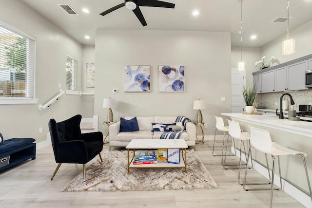 7215 Bennett Ave, Austin, TX 78752 - living room featuring light wood-style floors, a ceiling fan, and recessed lighting