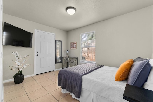 7215 Bennett Ave, Austin, TX 78752 - bedroom featuring light tile patterned floors and baseboards