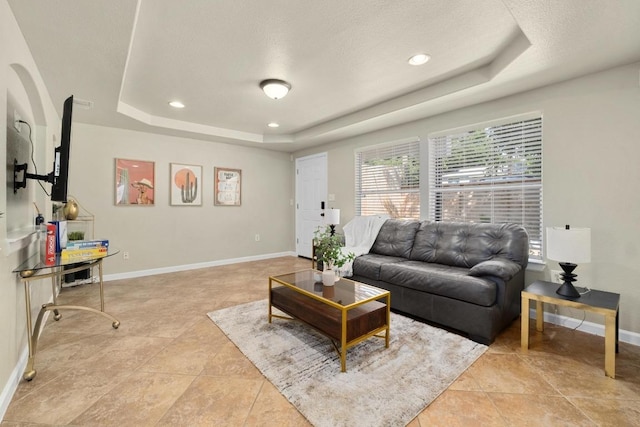 7215 Bennett Ave, Austin, TX 78752 - living area featuring a tray ceiling, light tile patterned flooring, recessed lighting, and a textured ceiling