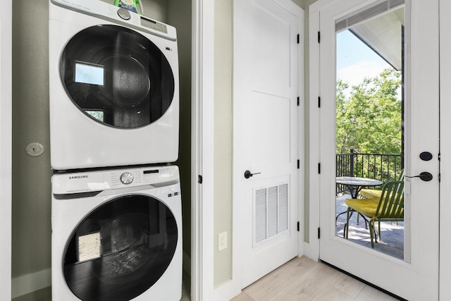 7215 Bennett Ave, Austin, TX 78752 - laundry room with stacked washer / dryer and light wood finished floors