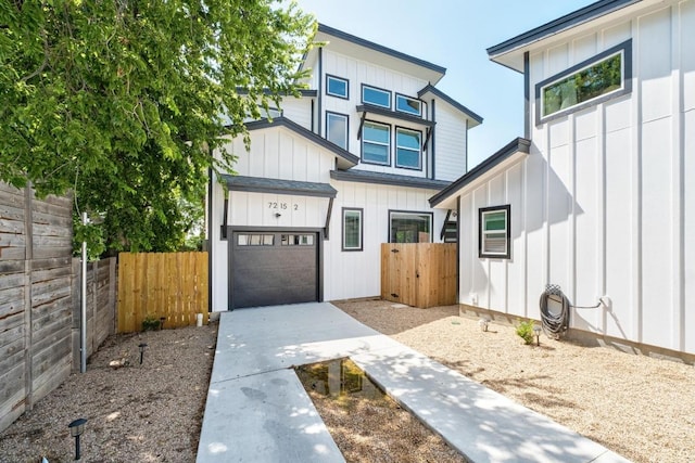 7215 Bennett Ave, Austin, TX 78752 - view of front of home with board and batten siding, driveway, and a garage