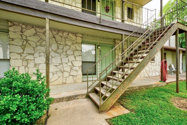 4307 S 1st St Unit 103, Austin, TX 78745 - doorway to property featuring stone siding and a patio