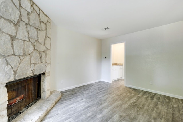 4307 S 1st St Unit 103, Austin, TX 78745 - unfurnished living room featuring wood finished floors and a fireplace