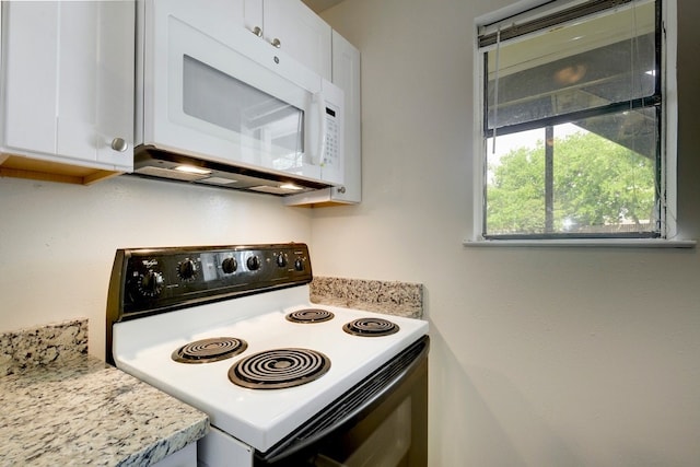 4307 S 1st St Unit 103, Austin, TX 78745 - kitchen featuring range with electric cooktop, white microwave, white cabinets, and light countertops