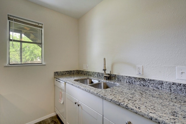 4307 S 1st St Unit 103, Austin, TX 78745 - kitchen with white dishwasher, white cabinets, and light stone counters