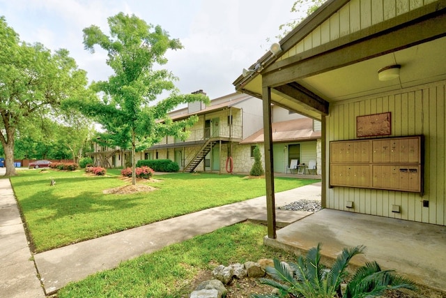 4307 S 1st St Unit 103, Austin, TX 78745 - view of green lawn featuring mail area and stairway