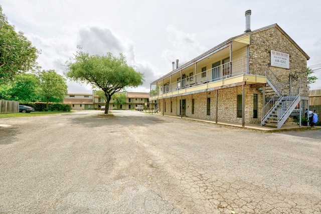 4307 S 1st St Unit 103, Austin, TX 78745 - view of property with stairway and uncovered parking
