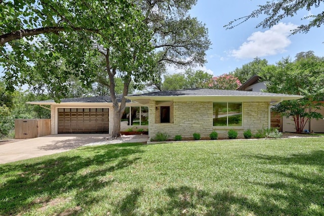 3518 Lakeland Dr, Austin, TX 78731 - view of front of home featuring stone siding, an attached garage, concrete driveway, and a front yard