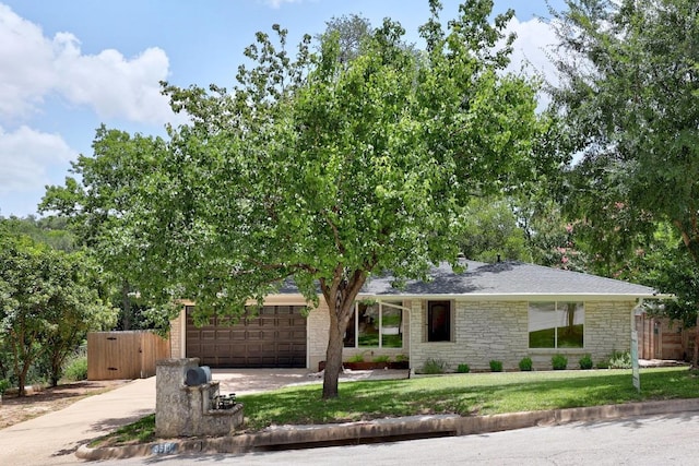 3518 Lakeland Dr, Austin, TX 78731 - view of front facade featuring stone siding, concrete driveway, a garage, and a gate