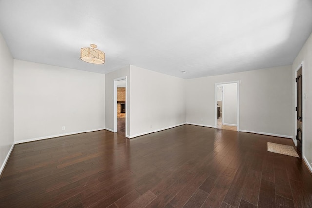 3518 Lakeland Dr, Austin, TX 78731 - unfurnished living room featuring baseboards and wood finished floors