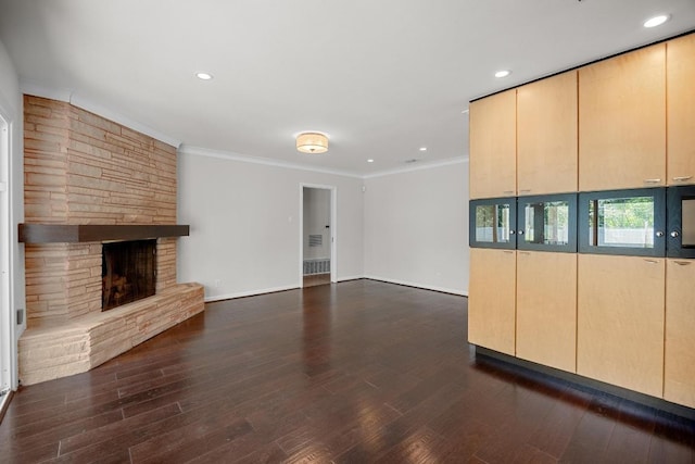 3518 Lakeland Dr, Austin, TX 78731 - unfurnished living room featuring a stone fireplace, dark wood finished floors, ornamental molding, and recessed lighting
