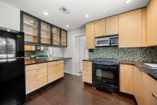 3518 Lakeland Dr, Austin, TX 78731 - kitchen with black appliances, light brown cabinetry, dark countertops, and recessed lighting